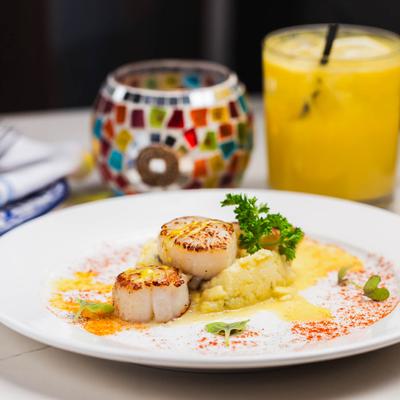 Seared scallops plate, served.