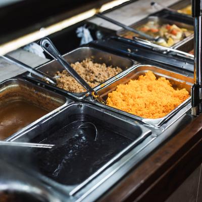 Buffet station featuring several stainless steel food pans.