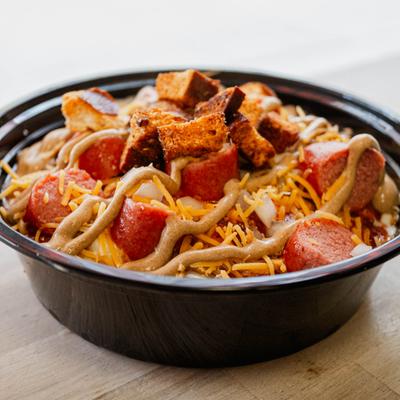 Chili Dawg Mac Bowl with hot dog bites, diced onions, shredded cheese and croutons.