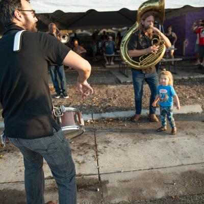 Exterior, brass band performing.