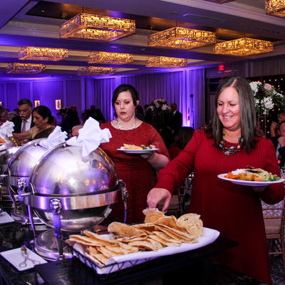 Girls grabbing food from the catering table