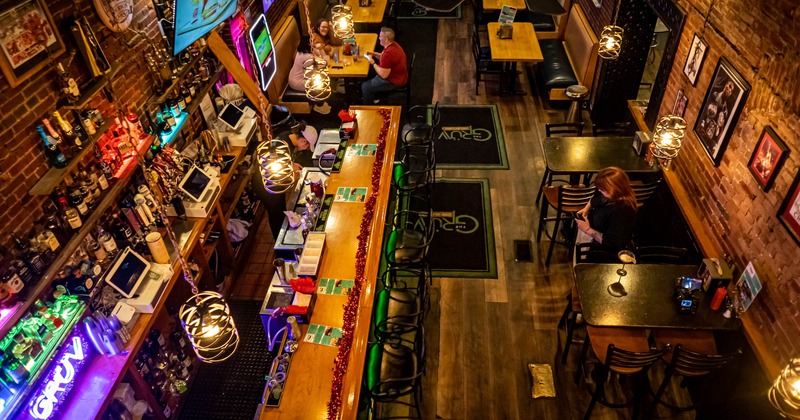 Interior, overhead view, dining area, bar stools, bar on the left