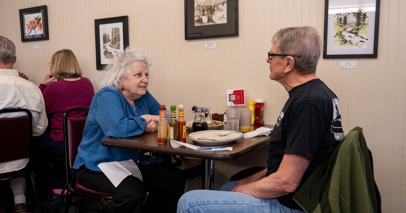 Table for two by the wall, guests