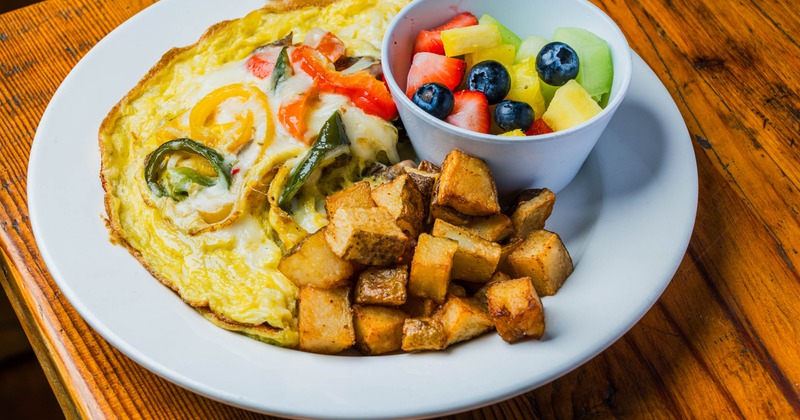 California Omelet served with a bowl of mixed fruit and home fries