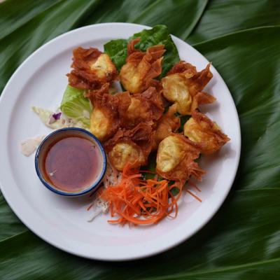 Crab Wontons served with fresh vegetables and a dipping sauce.