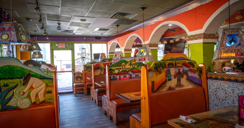 Interior of a colorful restaurant with painted booth backrests