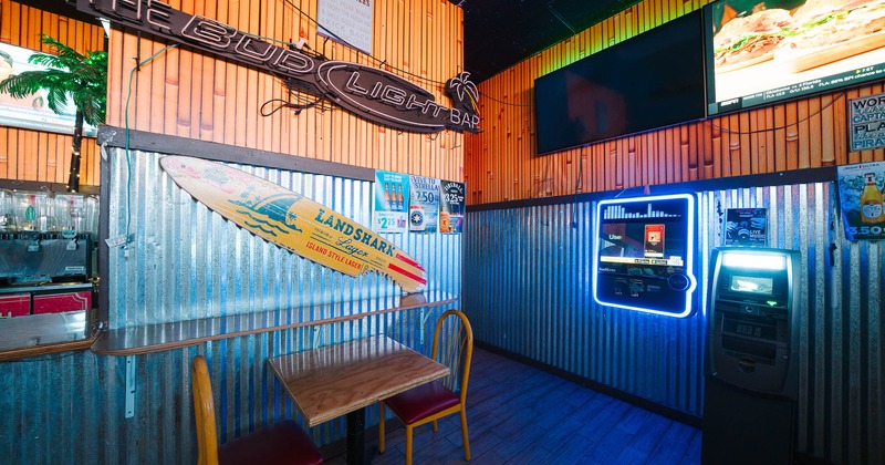 Dining table and and a surf board mounted on the wall