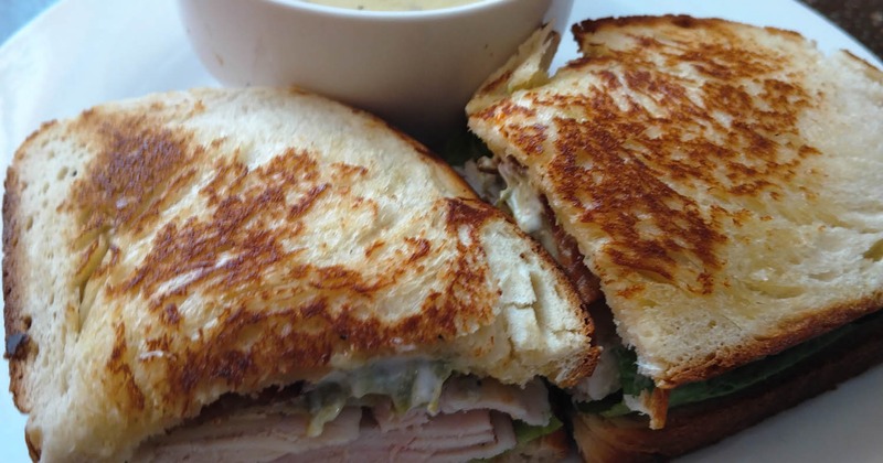 Ham and Swiss sandwich and a cup of soup