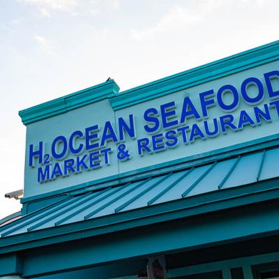 Restaurant exterior sign with blue lettering.