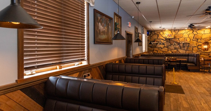 Inside, booths next to windows, pictures on the walls