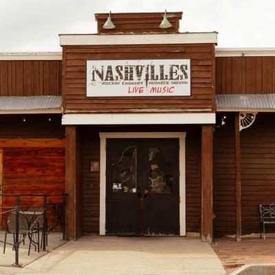 Storefront featuring rustic wooden exterior, entrance and signage.