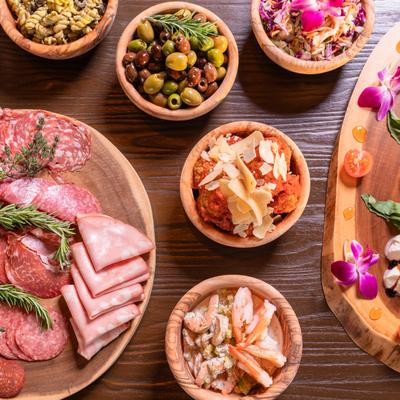 Charcuterie board, side dishes, and burrata board, top view.
