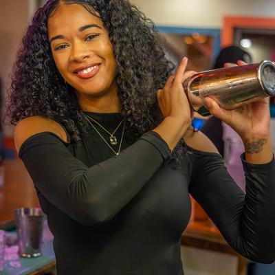 A person making a cocktail.