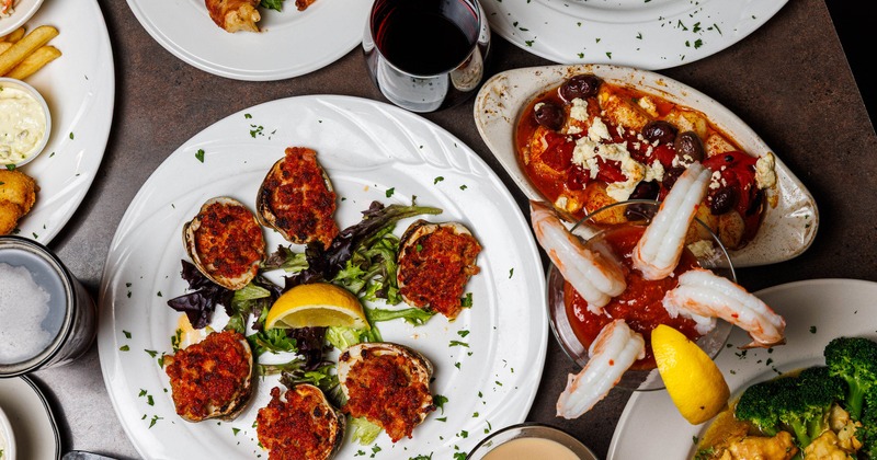 Assorted seafood dishes arranged across a dining table