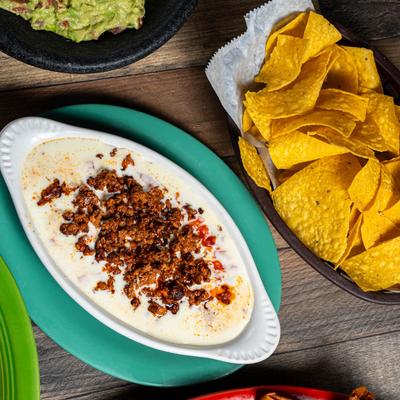 Chile con queso served with tortilla chips on the side.
