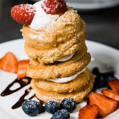Pastry dessert with cream and fresh berries.