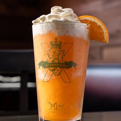 Tavern Slushie with whipped cream and orange slice garnish.