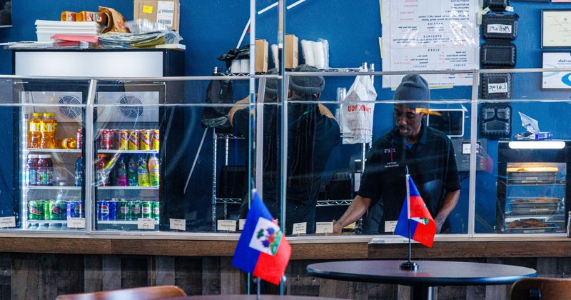 Diner table, food counter behind, staff