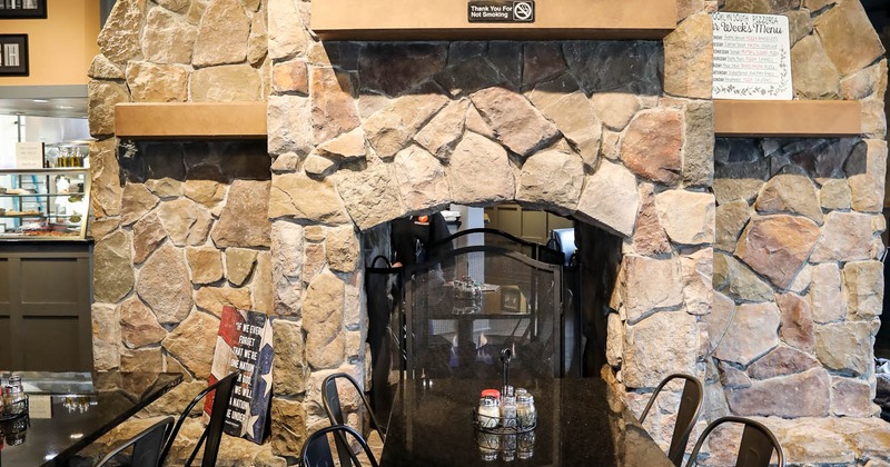 Table and chairs, large TV set on the wall