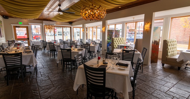 Interior, dining area, white cloth tables for four and eight, tile flooring, entrance