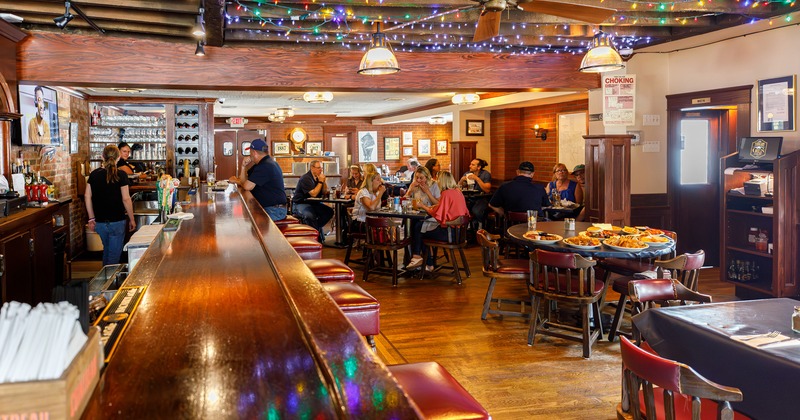 Interior space, bar and dining area with guests enjoying their food
