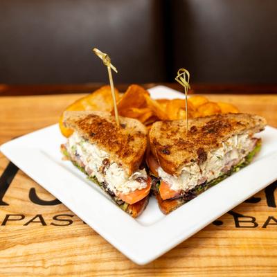 Chicken salad sandwich, served with potato chips.