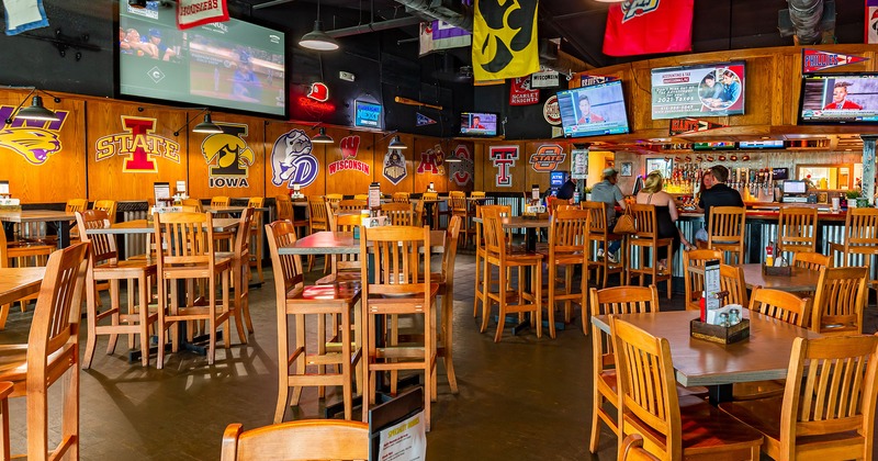 Interior, seating, bar, TVs and sports logo and banner decorations around the room