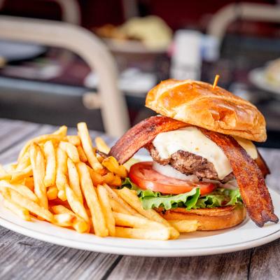 Bacon Cheeseburger served with fries on the side.