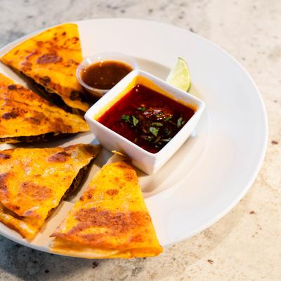 Quesabirria served with two dips.