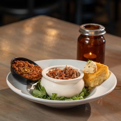 Carolina Style Chopped Pork, spicy beans, cornbread, and arugula.