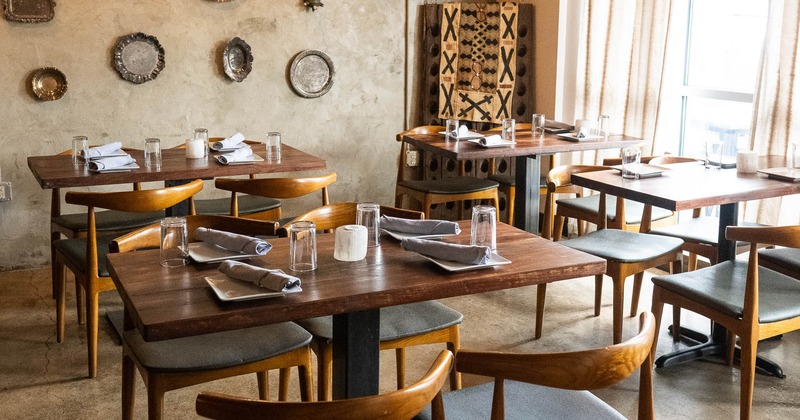 Interior, tables set for guests in dining area