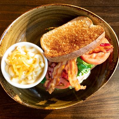 Grilled bacon, salad, toasted bread and pasta on the side.