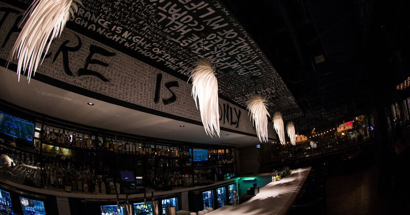 Interior, dim lit bar decorated with modern feather pendant lights
