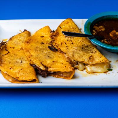Birria Quesadillas served with consomee on the side.