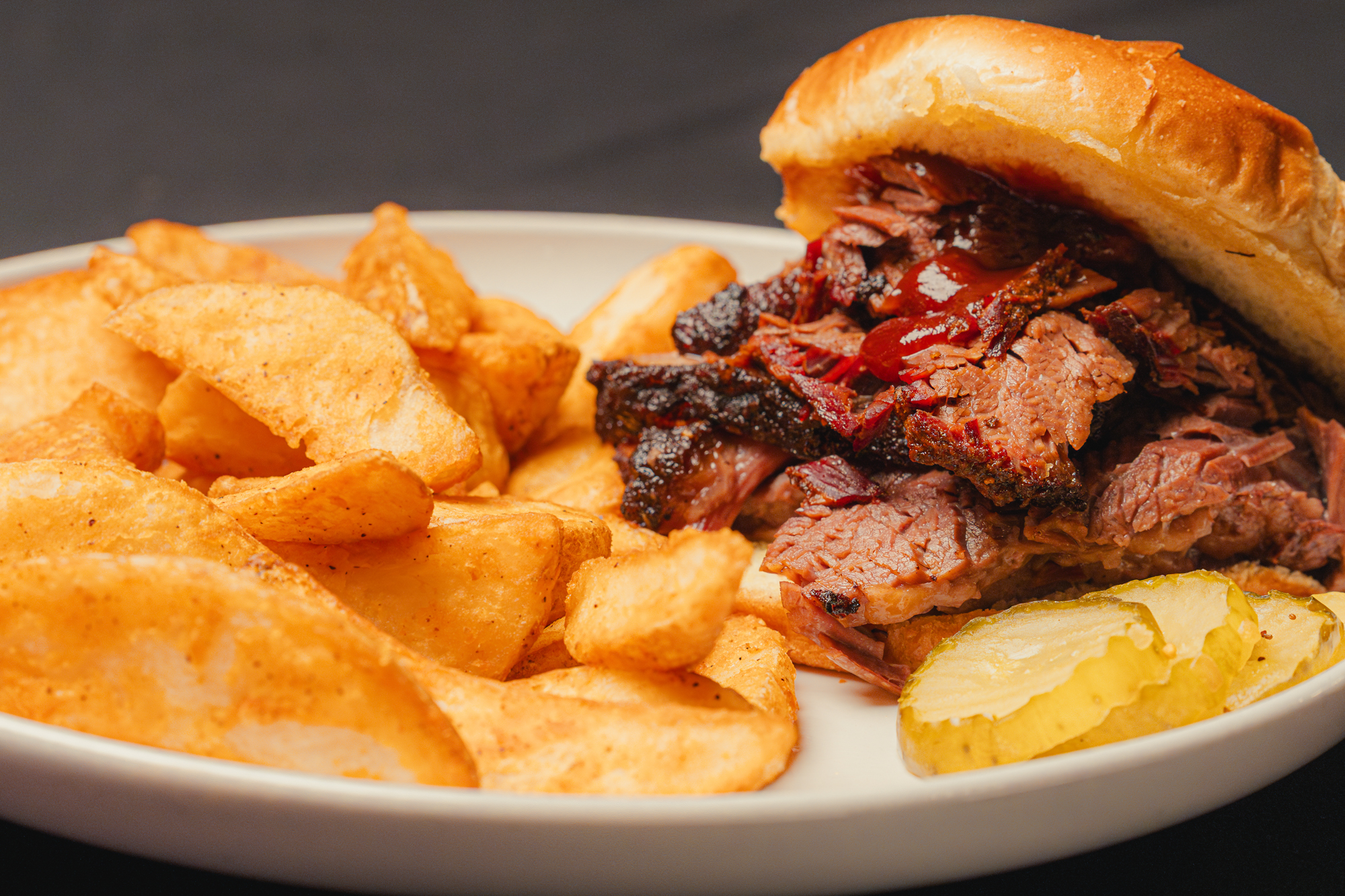 Brisket burnt ends sandwich with potato wedges