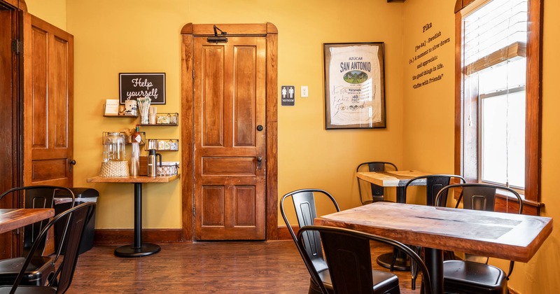 Interior, seating area, wooden doors, waiter serving station, framed T-shirt, window