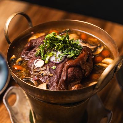 Spicy Pork Hock Soup with mushroom, tomato, lemongrass, chili, cilantro and shallot.