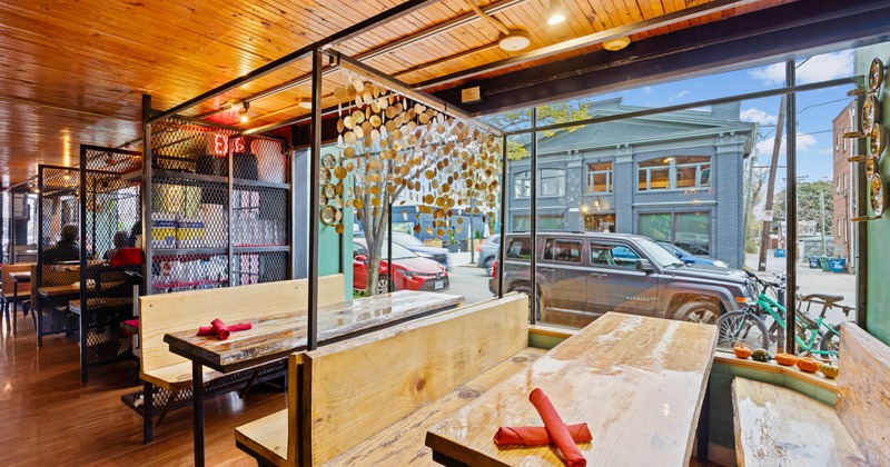 Wooden benches and tables by the window