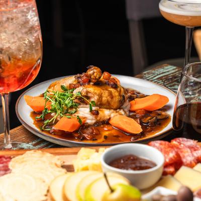 Hunter Chicken, served on the table with other disshes and drinks.