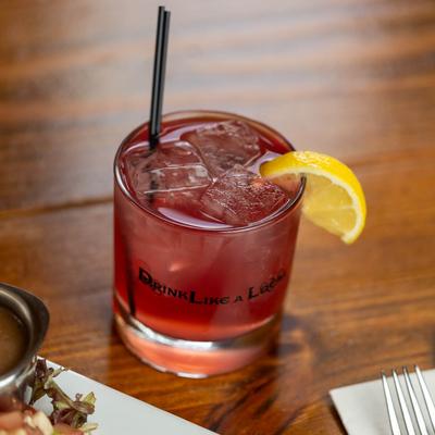 Strawberry Fields cocktail with lemon wedge garnish.