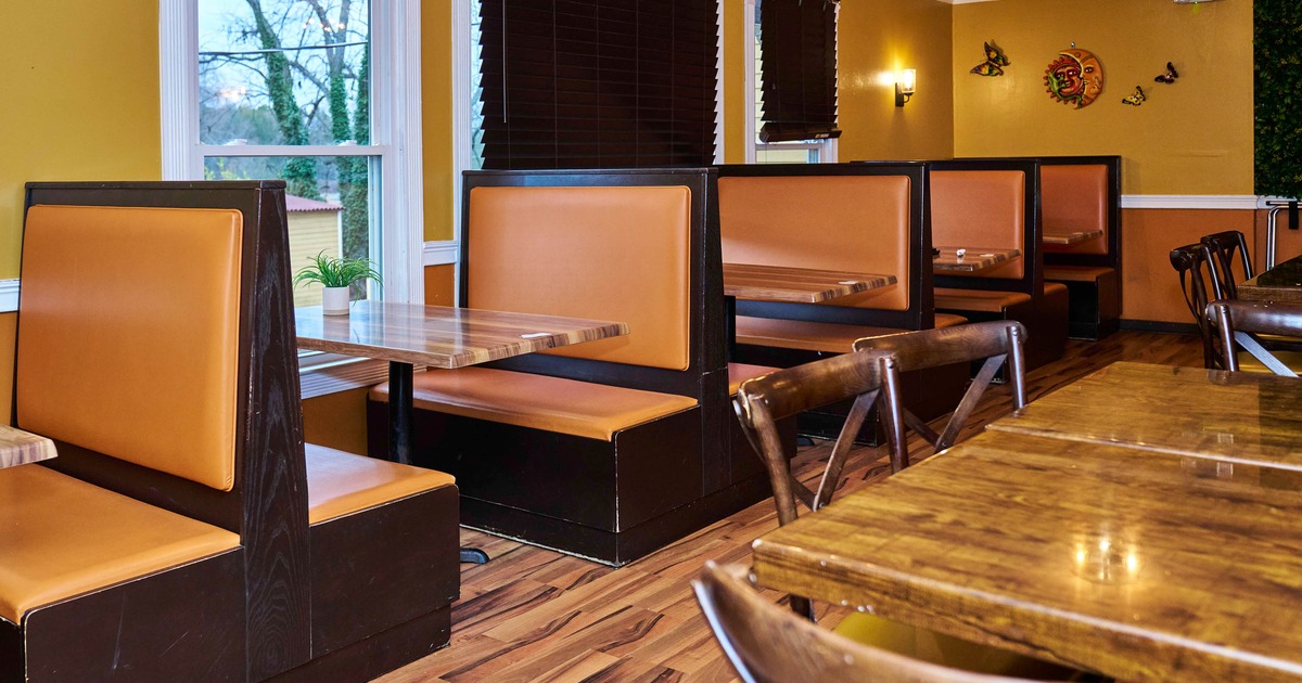 Interior, dining area, seating booths with tables, windows with blinds