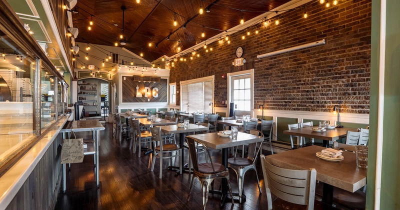 Interior, dining area, tables with chairs, ready for guests, red brick walls