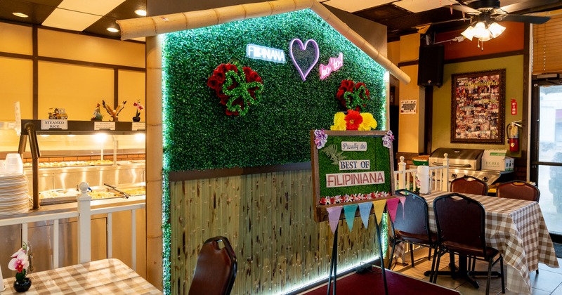 Diner area, tables, chairs, green plant, photo wall