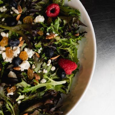 Mixed greens salad with berries, nuts, raisins, and gorgonzola cheese.