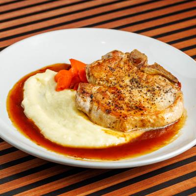 Bourbon glazed pork chop with mashed potatoes.