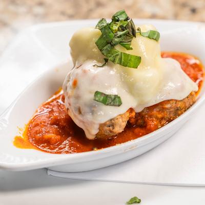 Homemade meatballs, topped with melted cheese.