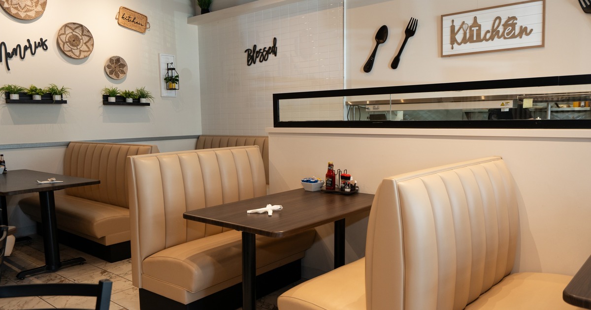 Interior, dining area with beige leather booths and tables