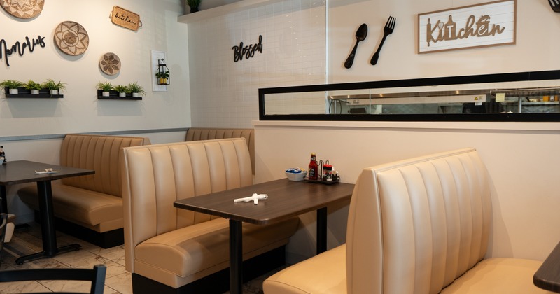 Interior, dining area with beige leather booths and tables