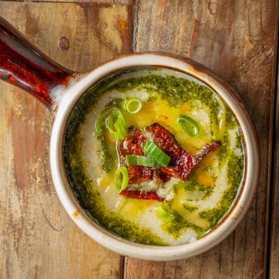 Grits with pesto, scallions, and bacon.