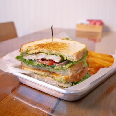 Served pesto chicken sandwich.